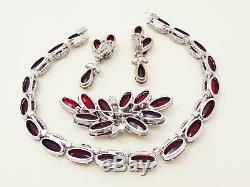 A vintage 1960's unsigned Kramer, ruby rhinestone parure of necklace, brooch and
