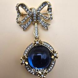 Vintage gold tone rhinestones bow dangle blue glass Cabochon designer brooch