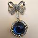 Vintage gold tone rhinestones bow dangle blue glass Cabochon designer brooch